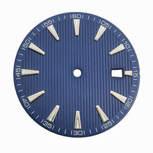 Blue-toned, striped dress watch dial with applied baton hour markers